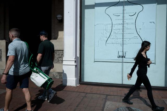 People pass the pop-up exhibit "Donald J. Trump and Jeffrey Epstein Memorial Reading Room" where 3,437 bound volumes of the "Epstein Files" are on display in Washington, DC, on June 9, 2026. (Photo by Brendan Smialowski / AFP)