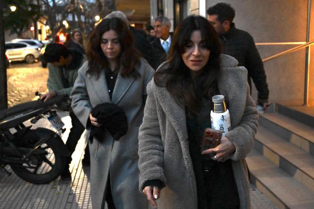 Gianinna Maradona (R) and Dalma Maradona, daughters of late Argentine football legend Diego Maradona, leave the court after a hearing in the trial into her father's death, in San Isidro, Buenos Aires province, Argentina, on June 9, 2026. (Photo by Luis ROBAYO / AFP)