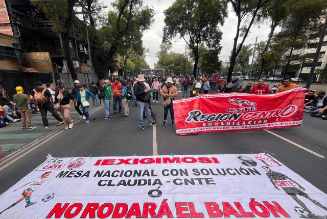Teachers and studens from Ayotzinapa school march to the Ciudad de Mexico Stadium in Mexico City on June 9, 2026. Thousands of teachers blocked an avenue leading to the Azteca Stadium in Mexico City, 48 hours before the opening ceremony of the 2026 World Cup at that venue. (Photo by Gerardo Magallon / AFP)