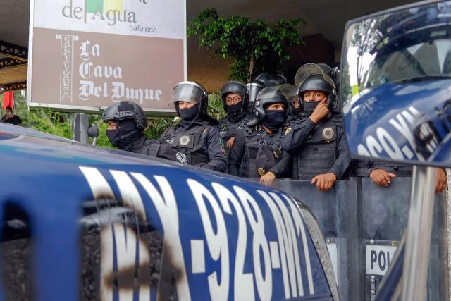 Members of the police block the way to the Ciudad de Mexico Stadium during a protest in Mexico City on June 9, 2026. Thousands of teachers blocked an avenue leading to the Azteca Stadium in Mexico City, 48 hours before the opening ceremony of the 2026 World Cup at that venue. (Photo by Gerardo Magallon / AFP)