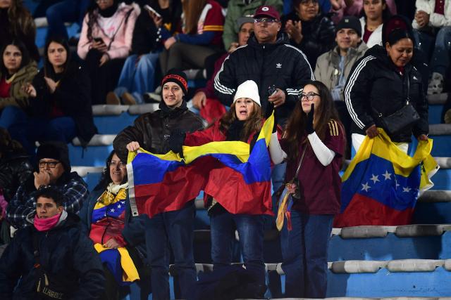 Fans of Venezuela cheer for their team during the CONMEBOL Nations League Women football match between Uruguay and Venezuela at the Centenario stadium in Montevideo on June 9, 2026. (Photo by Dante FERNANDEZ / AFP)