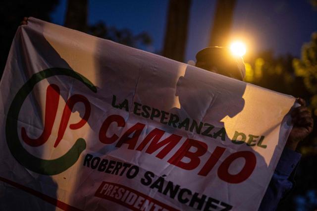 A supporter of Peru's presidential candidate Roberto Sanchez, for the Juntos por el Peru party, protests in front of the National Election Jury (JNE) in Lima on June 9, 2026. The head of Peru's election authority told AFP that the results of the June 7 presidential election may not be known for up to two weeks, dashing hopes of a swift resolution to the ultra-tight race. (Photo by ERNESTO BENAVIDES / AFP)