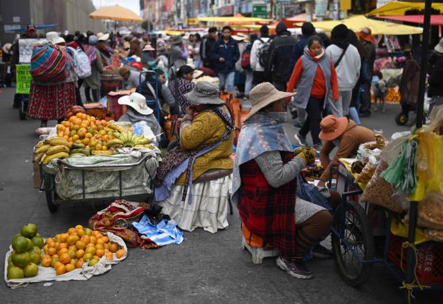Locals offer their goods at an improvised market along a blocked highway in the Rio Seco area of El Alto, Bolivia, on June 9, 2026. The road, a key transport corridor linking La Paz with Copacabana and the border town of Desaguadero, has been transformed into a bustling marketplace where hundreds of vendors sell food and other goods as anti-government road blockades continue across the country amid growing political tensions and supply shortages. (Photo by Marvin RECINOS / AFP)