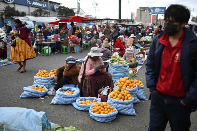 Locals offer their goods at an improvised market along a blocked highway in the Rio Seco area of El Alto, Bolivia, on June 9, 2026. The road, a key transport corridor linking La Paz with Copacabana and the border town of Desaguadero, has been transformed into a bustling marketplace where hundreds of vendors sell food and other goods as anti-government road blockades continue across the country amid growing political tensions and supply shortages. (Photo by Marvin RECINOS / AFP)