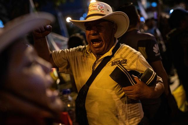 Supporters of Peru's presidential candidate Roberto Sanchez, for the Juntos por el Peru party, protest in front of the National Election Jury (JNE) in Lima on June 9, 2026. The head of Peru's election authority told AFP that the results of the June 7 presidential election may not be known for up to two weeks, dashing hopes of a swift resolution to the ultra-tight race. (Photo by ERNESTO BENAVIDES / AFP)