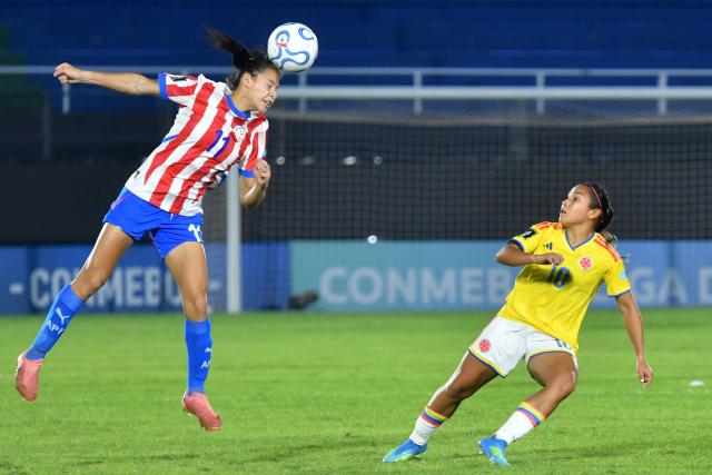 Paraguay's forward #11 Claudinha heads the ball past Colombia's midfielder #10 Leicy Santos during the CONMEBOL Nations League Women football match between Paraguay and Colombia at the Defensores del Chaco stadium in Asuncion on June 9, 2026. (Photo by DANIEL DUARTE / AFP)