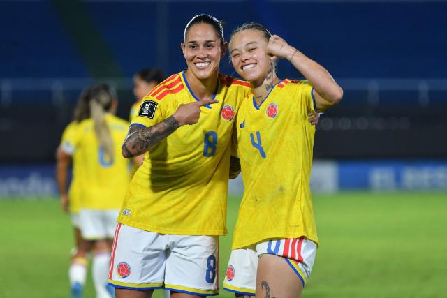Colombia's defender #04 Ana Guzman celebrates with her teammate Colombia's midfielder #08 Marcela Restrepo after scoring her team's fourth goal during the CONMEBOL Nations League Women football match between Paraguay and Colombia at the Defensores del Chaco stadium in Asuncion on June 9, 2026. (Photo by DANIEL DUARTE / AFP)