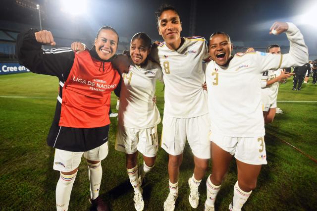 Venezuela's players celebrate qualification for the 2027 FIFA Women's World Cup at the end of the CONMEBOL Nations League Women football match between Uruguay and Venezuela at the Centenario stadium in Montevideo on June 9, 2026. (Photo by DANTE FERNANDEZ / AFP)