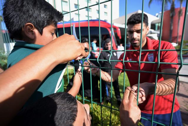 Iran's forward Mehdi Taremi signs autographs for fans outside the Marriott Hotel before leaving for a training session in Tijuana, Mexico, on June 9, 2026, ahead of the 2026 World Cup football tournament. (Photo by Guillermo Arias / AFP)