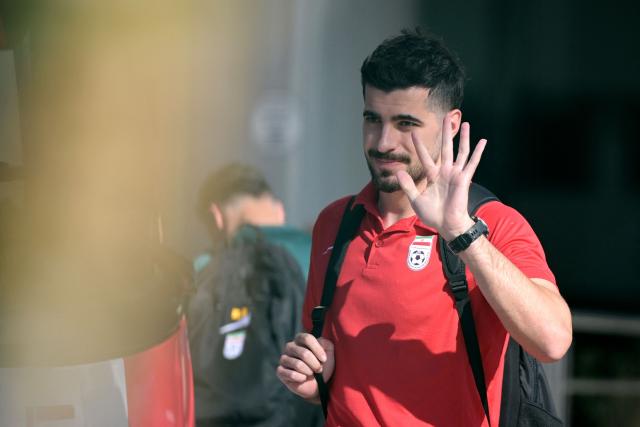 Iran's midfielder Saeid Ezatolahi waves to fans outside the Marriott Hotel before leaving for a training session in Tijuana, Mexico, on June 9, 2026, ahead of the 2026 World Cup football tournament. (Photo by Guillermo Arias / AFP)