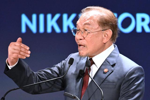 Malaysia's Prime Minister Anwar Ibrahim delivers a speech at the Nikkei Forum at a hotel in Tokyo on June 10, 2026. (Photo by Kazuhiro NOGI / AFP)
