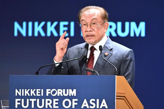 Malaysia's Prime Minister Anwar Ibrahim delivers a speech at the Nikkei Forum at a hotel in Tokyo on June 10, 2026. (Photo by Kazuhiro NOGI / AFP)
