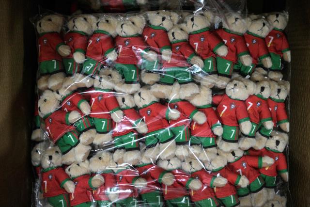 This photo taken on June 5, 2026, shows merchandise for Cristiano Ronaldo of Portugal's national football team, which will participate in the FIFA World Cup 2026, at the All Star Partner factory in Yiwu in eastern China's Zhejiang province. Stuffed "goat" plushies donning Lionel Messi's famous Argentina no. 10 pepper a factory tabletop in eastern China, where sellers are betting on the country's lucrative fan market for a World Cup boost. (Photo by Hector RETAMAL / AFP) / To go with 'CHINA-CONSUMPTION-FBL,FOCUS' by Mary YANG