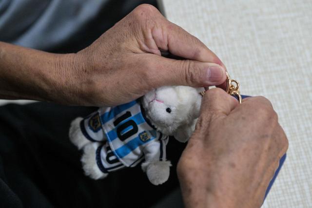 In this photo taken on June 5, 2026, a worker packs merchandise of Lionel Messi of Argentina's national football team, which will participate in the FIFA World Cup 2026, at the All Star Partner factory in Yiwu in eastern China's Zhejiang province. Stuffed "goat" plushies donning Lionel Messi's famous Argentina no. 10 pepper a factory tabletop in eastern China, where sellers are betting on the country's lucrative fan market for a World Cup boost. (Photo by Hector RETAMAL / AFP) / To go with 'CHINA-CONSUMPTION-FBL,FOCUS' by Mary YANG