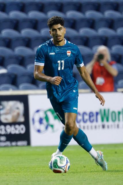 Iraq's forward #11 Ahmed Qasim controls the ball during the international friendly football match between Iraq and Venezuela at SeatGeek Stadium in Bridgeview, Illinois on June 9, 2026. (Photo by KAMIL KRZACZYNSKI / AFP)