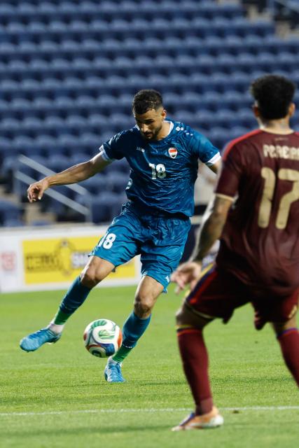 Iraq's forward #18 Aymen Hussein controls the ball during the international friendly football match between Iraq and Venezuela at SeatGeek Stadium in Bridgeview, Illinois on June 9, 2026. (Photo by KAMIL KRZACZYNSKI / AFP)