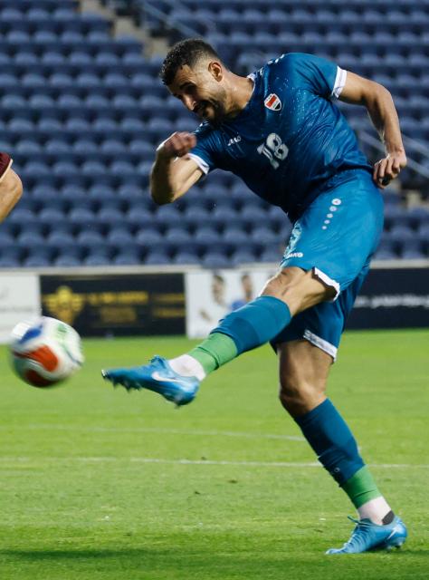 Iraq's forward #18 Aymen Hussein kicks the ball during the international friendly football match between Iraq and Venezuela at SeatGeek Stadium in Bridgeview, Illinois on June 9, 2026. (Photo by KAMIL KRZACZYNSKI / AFP)