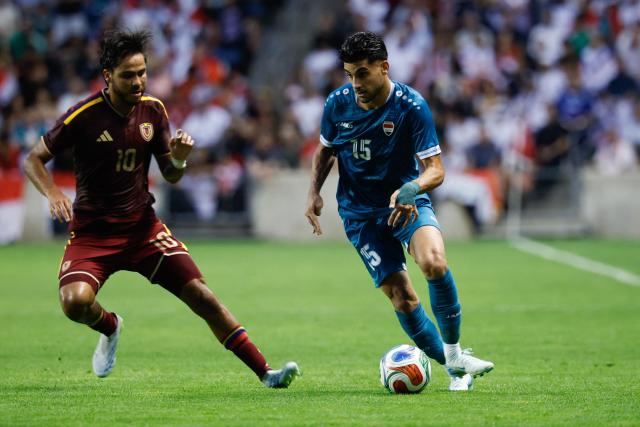 Iraq's defender #15 Ahmed Maknzi controls the ball as Venezuela's midfielder #10 Telasco Segovia defends during the international friendly football match between Iraq and Venezuela at SeatGeek Stadium in Bridgeview, Illinois on June 9, 2026. (Photo by KAMIL KRZACZYNSKI / AFP)