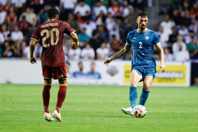Iraq's defender #02 Rebin Sulaka controls the ball while Venezuela's forward #20 Ender Echenique defends during the international friendly football match between Iraq and Venezuela at SeatGeek Stadium in Bridgeview, Illinois on June 9, 2026. (Photo by KAMIL KRZACZYNSKI / AFP)