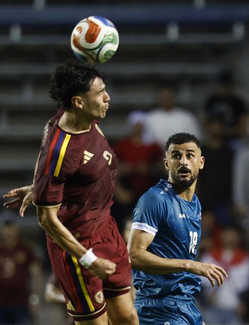 Venezuela's defender #02 Nahuel Ferraresi and Iraq's forward #18 Aymen Hussein vie for the ball during the international friendly football match between Iraq and Venezuela at SeatGeek Stadium in Bridgeview, Illinois on June 9, 2026. (Photo by KAMIL KRZACZYNSKI / AFP)