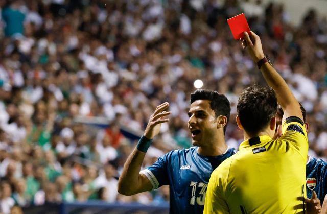 Referee shows a red card to Iraq's forward #13 Ali Yousif during the international friendly football match between Iraq and Venezuela at SeatGeek Stadium in Bridgeview, Illinois on June 9, 2026. (Photo by KAMIL KRZACZYNSKI / AFP)