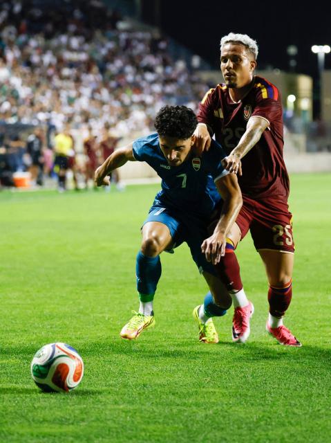 Iraq's midfielder #07 Amyn Youssef and Venezuela's midfielder #25 Edson Tortolero vie for the ball during the international friendly football match between Iraq and Venezuela at SeatGeek Stadium in Bridgeview, Illinois on June 9, 2026. (Photo by KAMIL KRZACZYNSKI / AFP)