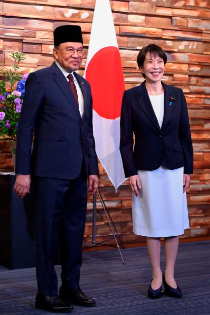 Japan's Prime Minister Sanae Takaichi (R) and Malaysia's Prime Minister Anwar Ibrahim (L) pose for photographs ahead of their bilateral meeting at the Prime Minister’s Office in Tokyo on June 10, 2026. (Photo by David Mareuil / POOL / AFP)