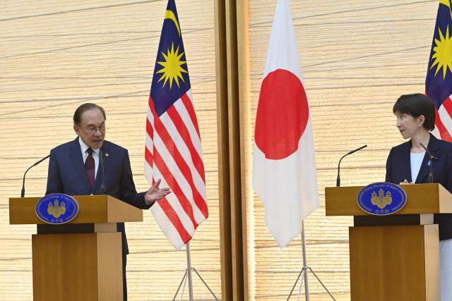 Japan's Prime Minister Sanae Takaichi (R) and Malaysia's Prime Minister Anwar Ibrahim (L) hold a joint press announcement following their bilateral meeting at the Prime Minister’s Office in Tokyo on June 10, 2026. (Photo by David Mareuil / POOL / AFP)
