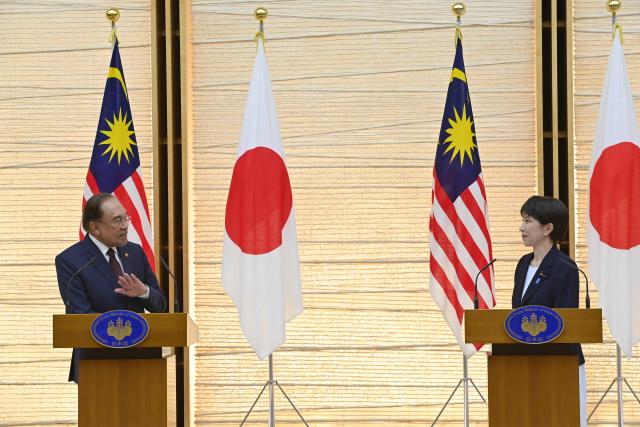 Japan's Prime Minister Sanae Takaichi (R) and Malaysia's Prime Minister Anwar Ibrahim (L) hold a joint press announcement following their bilateral meeting at the Prime Minister’s Office in Tokyo on June 10, 2026. (Photo by David Mareuil / POOL / AFP)