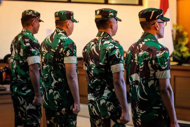 Four Indonesian military personnel accused of throwing acid at a human rights activist attend a verdict hearing at a military court in Jakarta on June 10, 2026. A military court in Indonesia on June 10 sentenced four soldiers to up to three years in prison for an acid attack on an activist critical of perceived militarisation of the government. (Photo by Yasuyoshi Chiba / AFP)