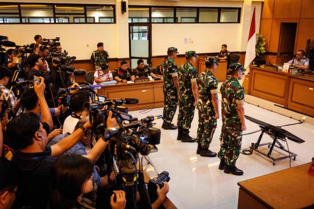 Four Indonesian military personnel accused of throwing acid at a human rights activist attend a verdict hearing at a military court in Jakarta on June 10, 2026. A military court in Indonesia on June 10 sentenced four soldiers to up to three years in prison for an acid attack on an activist critical of perceived militarisation of the government. (Photo by Yasuyoshi Chiba / AFP)