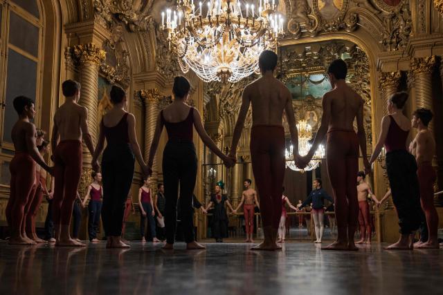 Female and male students from the 2nd division of the Paris Opera Dance School warm up before a performance in the Foyer de la Danse at the Opera Garnier in Paris on December 15, 2024. It is a tradition passed down orally, from one generation of young dancers to the next: at the Paris Opera Ballet School, students are taught the art of French classical ballet, a three-century-old artistic heritage that is attracting more and more foreign dancers. (Photo by JOEL SAGET / AFP)
