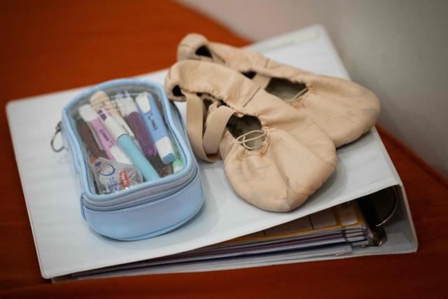 Dance shoes and binders are photographed at the Paris Opera Ballet School, West of Paris, on November 18, 2025. (Photo by JOEL SAGET / AFP)