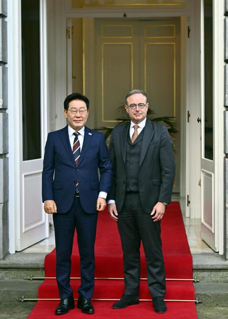 South Korean President Lee Jae Myung (R) and Belgium's Prime Minister Bart De Wever pose for photographers at the start of their diplomatic meeting in Brussels, on June 10, 2026. (Photo by ERIC LALMAND / Belga / AFP) / Belgium OUT