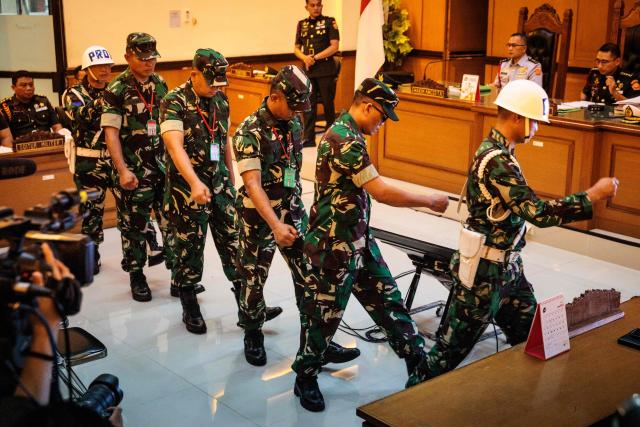 Four Indonesian military personnel accused of throwing acid at a human rights activist leave after a verdict hearing at a military court in Jakarta on June 10, 2026. A military court in Indonesia on June 10 sentenced four soldiers to up to three years in prison for an acid attack on an activist critical of perceived militarisation of the government. (Photo by Yasuyoshi Chiba / AFP)