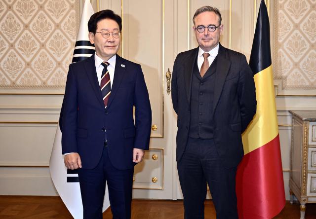 South Korean President Lee Jae Myung (R) and Belgium's Prime Minister Bart De Wever pose for photographers during their diplomatic meeting in Brussels, on June 10, 2026. (Photo by ERIC LALMAND / Belga / AFP) / Belgium OUT