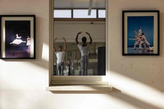 Students of the Paris Opera Dance School train between classes in Nanterre, West of Paris, on November 18, 2025. It is a tradition passed down orally, from one generation of young dancers to the next: at the Paris Opera Ballet School, students are taught the art of French classical ballet, a three-century-old artistic heritage that is attracting more and more foreign dancers. (Photo by JOEL SAGET / AFP)