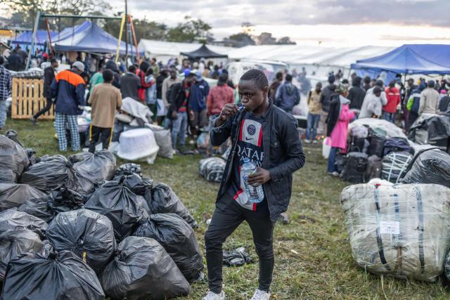 A foreign national brushes his teeth while taking refuge with others at a park in Durban on June 10, 2026 after fleeing their homes amid fears of xenophobic attacks. Hundreds of foreign nationals await repatriation to Malawi from South Africa following xenophobic violence in the country. Foreign nationals have told of intimidation and beatings by mobs going door-to-door to tell them to leave by June 30, a "deadline" regularly broadcast across social media, even though it has no official backing. Ghana, Mozambique and Malawi are among countries that have repatriated hundreds of their nationals this month, most of whom South Africa says did not have the correct documentation to be in the country. (Photo by RAJESH JANTILAL / AFP)