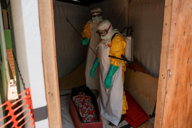 Volunteers from the Democratic Republic of Congo Red Cross prepare the body of a deceased child suspected of having died from Ebola virus for a funeral, at Salama Hospital in Bunia on June 9, 2026. (Photo by Jospin Mwisha / AFP)