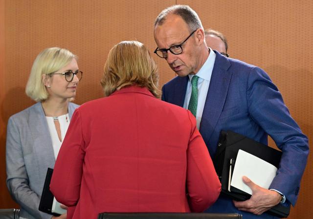 German Chancellor Friedrich Merz talks to German Minister for Labour and Social Affairs Baerbel Bas prior to the weekly cabinet meeting at the Chancellery in Berlin on June 10, 2026. (Photo by John MACDOUGALL / AFP)