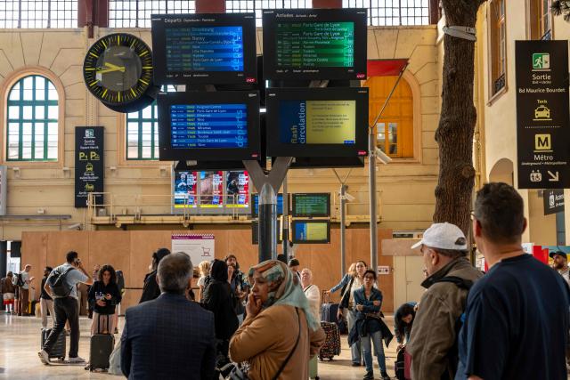 Commuters look at the screens indicating departure and arrival times as well as disruptions due to a SNCF national strike movement at the Saint-Charles train station in Marseille, southern France, on June 10, 2026. Some TGV high-speed trains are cancelled on June 10, morning, as well as regional and suburban trains, which are increasingly open to competition, as part of a 24-hour strike organized by SNCF unions. Traffic on June 10 morning is in line with forecasts, SNCF Voyageurs told AFP: regional traffic—the “everyday trains”—is “severely disrupted,” and on long-distance routes an average of one in three TGVs has been cancelled, along with one in two Intercitйs trains. (Photo by MIGUEL MEDINA / AFP)