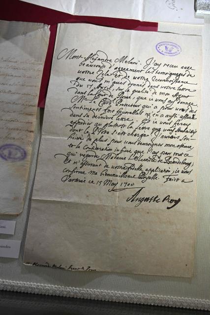 This photograph taken on June 5, 2026 shows a letter diplayed in a case during a press preview as part of the exhibition "Atto Melani (16261714). The Secret Voice of Power," at the Labronica Library of Villa Fabbricotti in Livorno on June 5, 2026. A celebrated singer in the courts of Tuscany, Venice, Rome, and France, a protégé of Cardinal Mazarin and close associate of the Sun King, Louis XIV of France, Atto Melani transformed his theatrical success into an extraordinary diplomatic career. Castrated as a child, he constantly struggled between public prestige and the human burden of his condition, yet he managed to become a political mediator, informer, and protagonist in the conclaves that marked the history of the papacy between 1667 and 1700. (Photo by Andreas SOLARO / AFP)