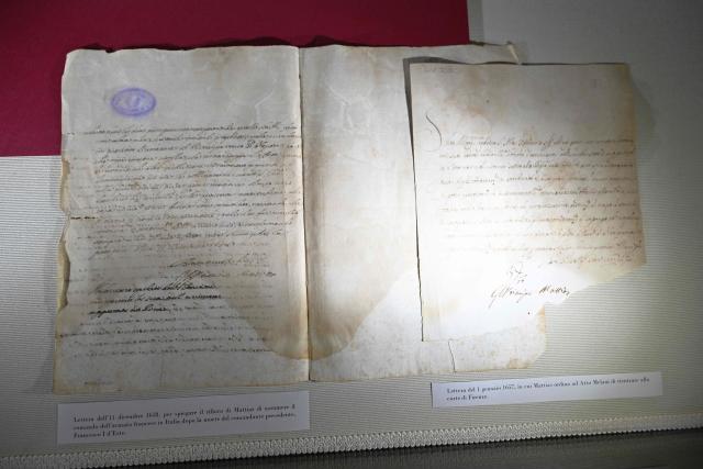 This photograph taken on June 5, 2026 shows letters diplayed in a case during a press preview as part of the exhibition "Atto Melani (16261714). The Secret Voice of Power," at the Labronica Library of Villa Fabbricotti in Livorno on June 5, 2026. A celebrated singer in the courts of Tuscany, Venice, Rome, and France, a protégé of Cardinal Mazarin and close associate of the Sun King, Louis XIV of France, Atto Melani transformed his theatrical success into an extraordinary diplomatic career. Castrated as a child, he constantly struggled between public prestige and the human burden of his condition, yet he managed to become a political mediator, informer, and protagonist in the conclaves that marked the history of the papacy between 1667 and 1700. (Photo by Andreas SOLARO / AFP)