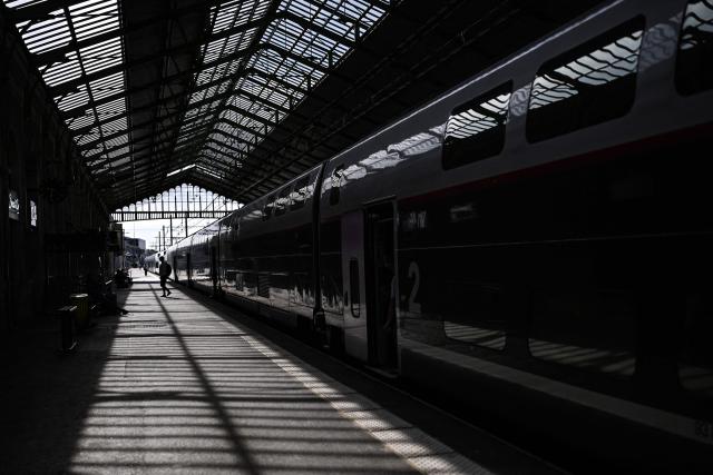 A passenger walks on a train platform at a railway station in Beziers, southern France, on June 10, 2026. Some TGV high-speed trains are cancelled on June 10, morning, as well as regional and suburban trains, as part of a 24-hour strike organized by SNCF unions as the four representative rail unions — CGT-Cheminots, UNSA-Ferroviaire, SUD-Rail and CFDT-Cheminots — called a one-day walkout for their first joint national action since late 2024, to denounce internal restructuring and demand higher wages. (Photo by Gabriel BOUYS / AFP)