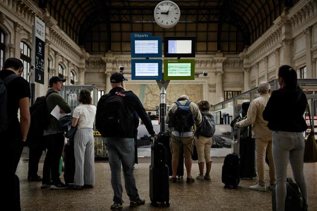 Travellers look at departure boards at the Saint-Jean railway station during a nationwide strike of French national railway company SNCF workers in Bordeaux, south-western France, on June 10, 2026. Some TGV high-speed trains are cancelled on June 10, morning, as well as regional and suburban trains, as part of a 24-hour strike organized by SNCF unions as the four representative rail unions — CGT-Cheminots, UNSA-Ferroviaire, SUD-Rail and CFDT-Cheminots — called a one-day walkout for their first joint national action since late 2024, to denounce internal restructuring and demand higher wages. (Photo by Philippe LOPEZ / AFP)