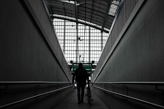 A man pushes his bicycle up a ramp leading to the platforms of the Saint-Jean railway station during a nationwide strike of French national railway company SNCF workers in Bordeaux, south-western France, on June 10, 2026. Some TGV high-speed trains are cancelled on June 10, morning, as well as regional and suburban trains, as part of a 24-hour strike organized by SNCF unions as the four representative rail unions — CGT-Cheminots, UNSA-Ferroviaire, SUD-Rail and CFDT-Cheminots — called a one-day walkout for their first joint national action since late 2024, to denounce internal restructuring and demand higher wages. (Photo by Philippe LOPEZ / AFP)