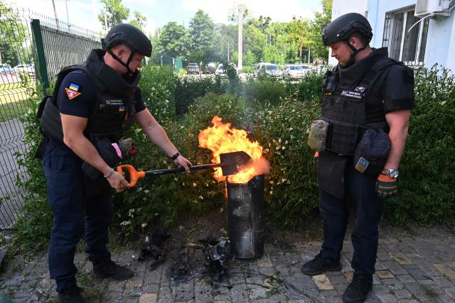 Ukrainian sappers burn off residual thermobaric material from the remnants of a munition following an air attack in Kharkiv on June 10, 2026, amid the Russian invasion of Ukraine. (Photo by SERGEY BOBOK / AFP)
