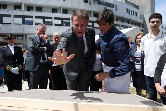 French President Emmanuel Macron (C-L) attends a handprint event during the foundation stone laying ceremony for the Child Brain Institute (ICE - Institut Robert-Debre du Cerveau de l’Enfant) at the Robert-Debre Hospital in Paris on June 10, 2026. (Photo by Gonzalo Fuentes / POOL / AFP)