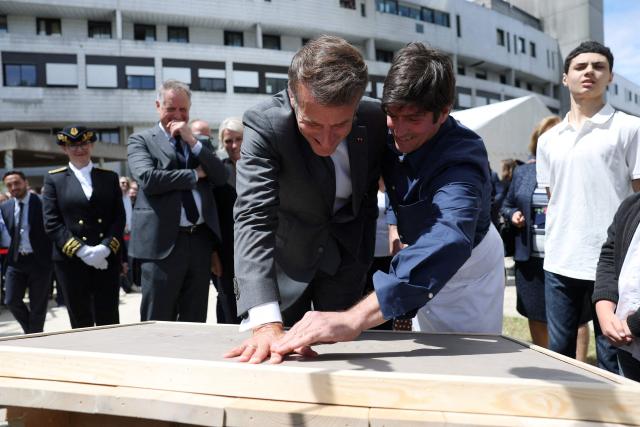 French President Emmanuel Macron (C-L) attends a handprint event during the foundation stone laying ceremony for the Child Brain Institute (ICE - Institut Robert-Debre du Cerveau de l’Enfant) at the Robert-Debre Hospital in Paris on June 10, 2026. (Photo by Gonzalo Fuentes / POOL / AFP)