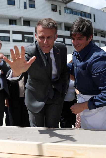 French President Emmanuel Macron (C-L) attends a handprint event during the foundation stone laying ceremony for the Child Brain Institute (ICE - Institut Robert-Debre du Cerveau de l’Enfant) at the Robert-Debre Hospital in Paris on June 10, 2026. (Photo by Gonzalo Fuentes / POOL / AFP)